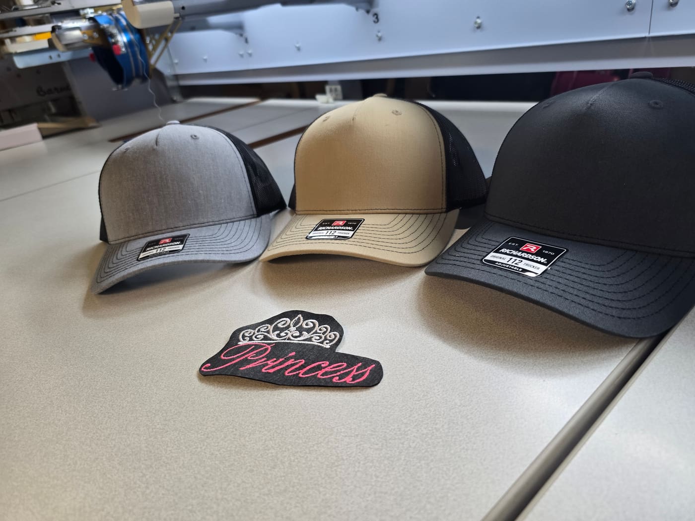 Hats stacked next to a princess patch